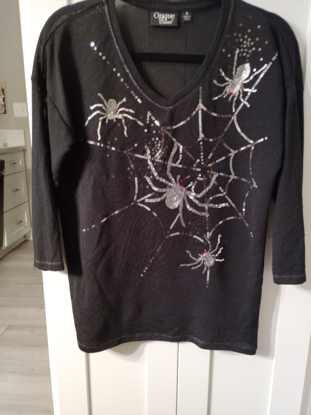 A black Halloween tunic embellished with a silver sequin spiders